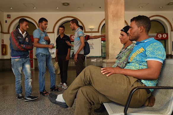 Men from Morocco who were some of the 415 people rescued off the Libyan coast by the Migrant Offshore Aid Station (MOAS) supported by Medecins Sans Frontieres (MSF) on the MY Phoenix wait for their train in Taranto, Italy.