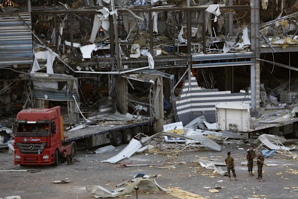 BEIRUT, LEBANON - AUGUST 05: Military personnel stand amid debris from nearby structures, damaged by an explosion a day earlier, on August 5, 2020 in Beirut, Lebanon. As of Wednesday morning, more than 100 people were confirmed dead, with thousands injured, when an explosion at the port rocked the Lebanese capital. Officials said a waterfront warehouse storing explosive materials, reportedly 2,700 tons of ammonium nitrate, was the cause of the blast. (Photo by Marwan Tahtah/Getty Images)