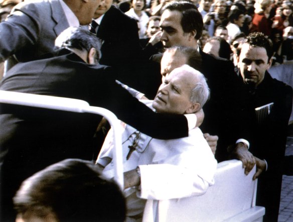 Pope John Paul lies wounded in St. Peter's Square after the assassination attempt.