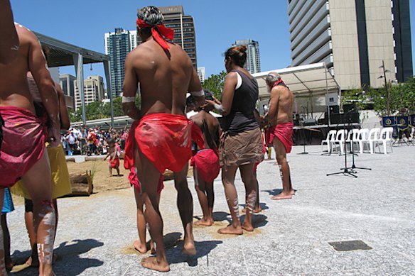 Performers put sand under their feet to escape the scalding temperature of King George Square's stone foundation. 