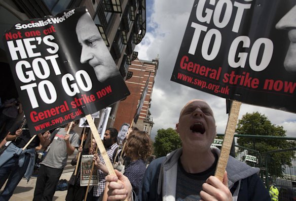 Protesters  outside Parliament  Square shout  anti-Murdoch slogans.