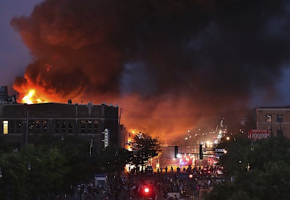 A large fire burns in Minneapolis during a third night of unrest.