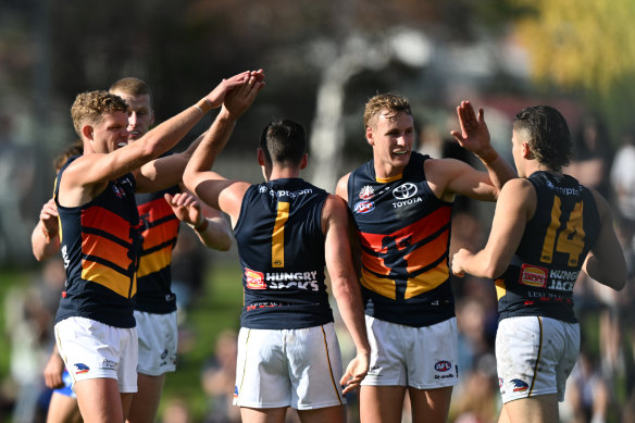 High fives: The Crows are in control at half-time.