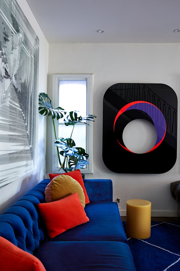 The renovated and expanded living room allows for extra seating, and large artworks
hang on the walls. The one on the far wall is by German artist Gerold Miller.