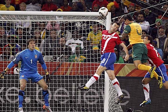 Australia's Tim Cahill fights for the ball with Serbia's Aleksandar Lukovic.