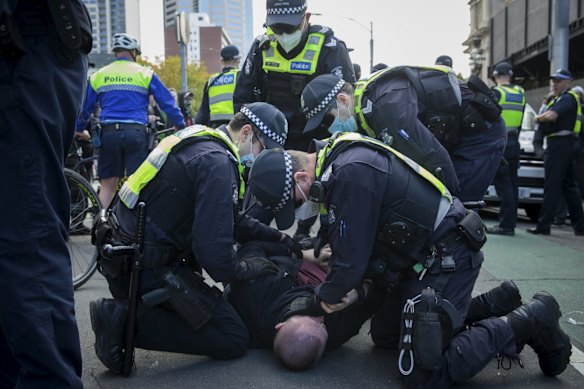 One man was brought to the ground by a number of police officers.