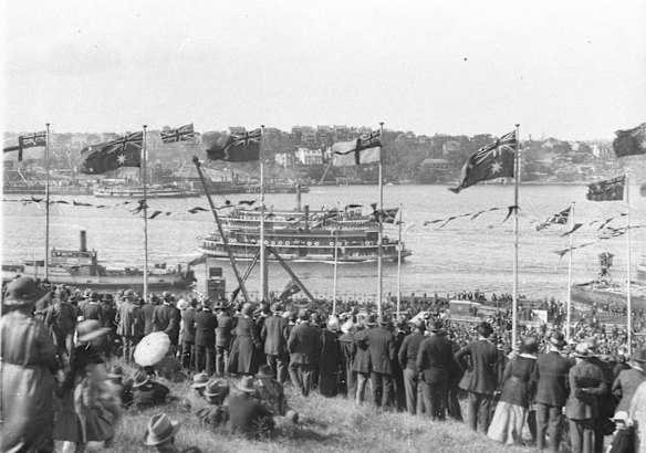 Crowds cheer from flag bedecked Dawes Point. Two ferries and a North Sydney vehicular ferry pass by, photographs by Sam Hood, 1925.