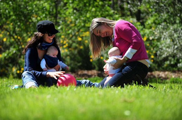 Canberra Capitals coach Carrie Graf, with partner Camille Chicheportische and baby twins Bentley (in blue ) and Charli (in red).