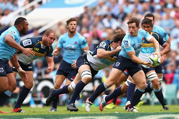 Bernard Foley of the Waratahs passes 