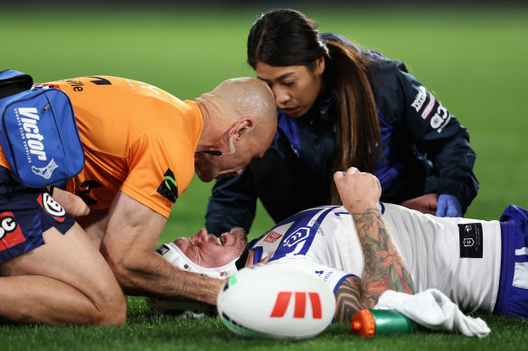 Ryan Sutton receives medical attention after being injured in a tackle.
