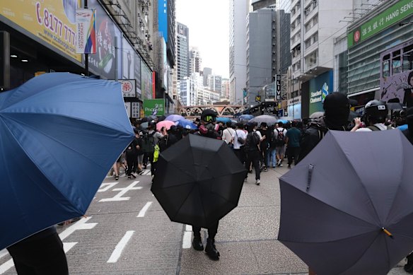 Demonstrators stand behind umbrellas during a protest against a planned national security law in the Causeway Bay district in Hong Kong, China.
