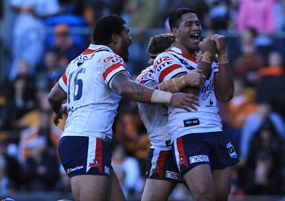 The Roosters' Lama Tasi celebrates his try.