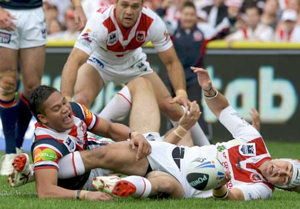 The Roosters Joseph Leilua and Jamie Soward watch as the ball goes loose for Braith Anasta to score.