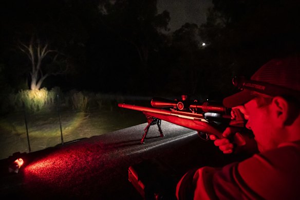 With a silenced .223 bolt action rifle at the ready, Biosecurity team leader Lee Parker scans for deer. 