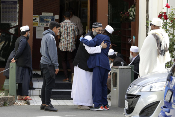 Muslim men embrace as they leave the Al Noor mosque in Christchurch, New Zealand.