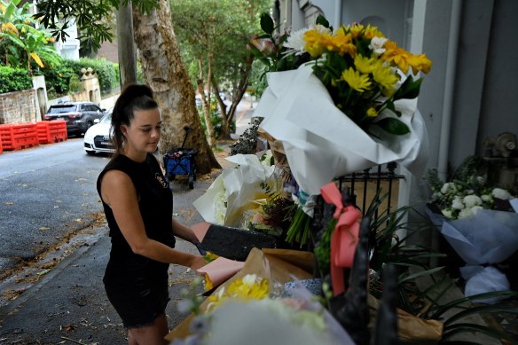 Davies’ childhood friend Emma Manning leaves floral tributes at the Paddington home where he died.
