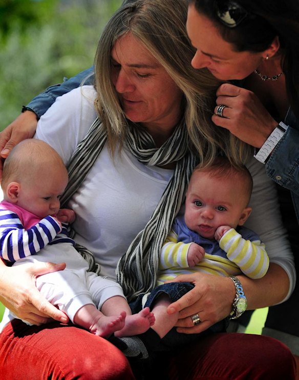 Canberra Capitals coach Carrie Graf, with partner Camille Chicheportische and baby twins Bentley (blue and yellow top) and Charli (blue and pink top).