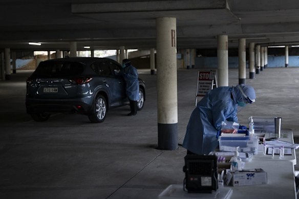 COVID-19 testing is carried out at the underground carpark at Marconi Stadium, Restwell Road, Bossley Park, as tighter lockdown restrictions are announced for Greater Sydney.