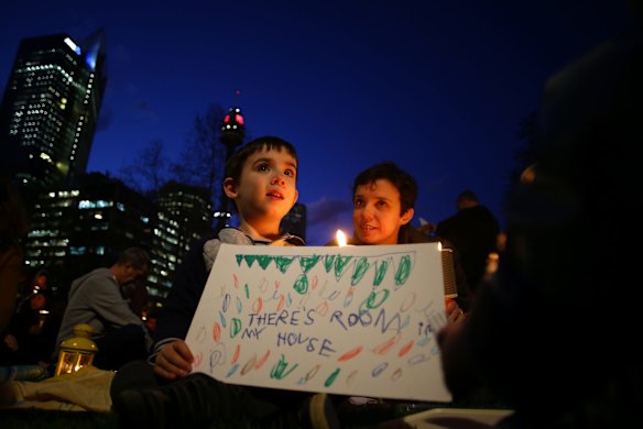 A boy holds a sign in support of refugees on September 7, 2015 in Sydney, Australia. 