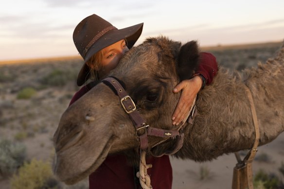 Sophie Matterson interacts with her lead camel Jude near a small clearing at Anna Creek  in Oodnadatta, Australia. Sophie Matterson, 32, is on a 5,000km journey - walking with five camels coast to coast from Australia's western-most point in Shark Bay, Western Australia, to its eastern-most point in Byron Bay, New South Wales.  