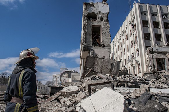 Rescuers work at the site of the National Academy of State Administration building damaged by shelling in Kharkiv, Ukraine.
