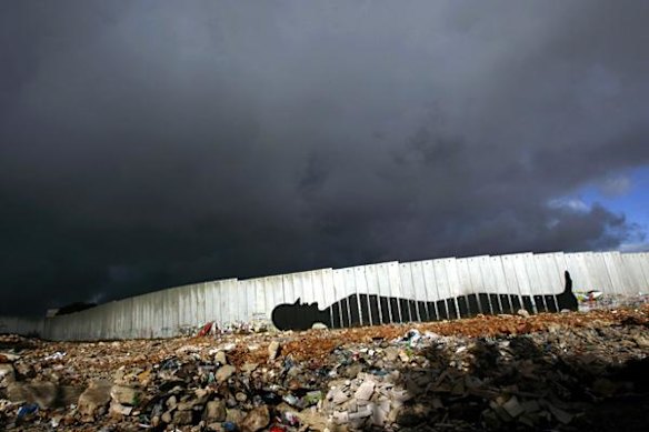 Graffiti painted by British artist Banksy on a section of Israel's separation barrier between Jerusalem and the West Bank.