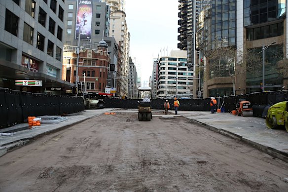 Workers prepare the road surface as progress continues on the Sydney Light Rail on the corner of Bridge and George St.