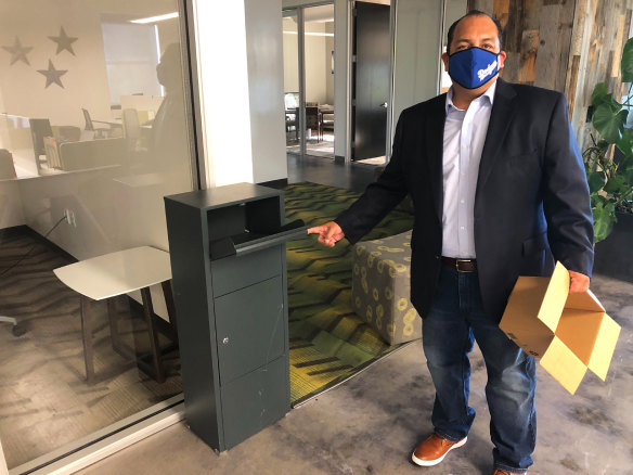 California Republican Party spokesman Hector Barajas demonstrates how to use one of the party's unofficial ballot drop boxes.