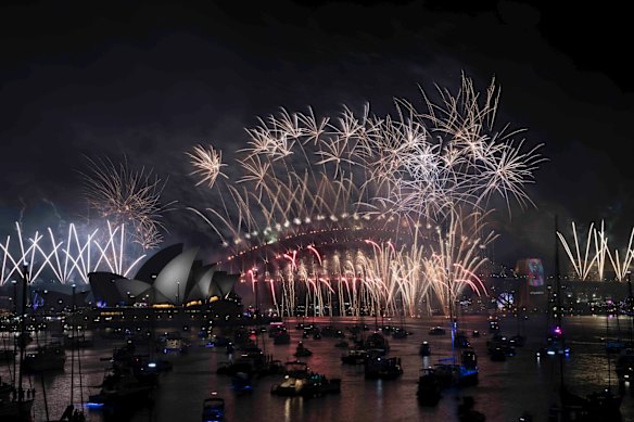 The New Years Eve Midnight fireworks light up the Sydney Harbour Bridge and Opera House.