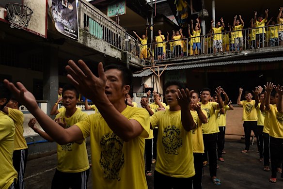 Prisoners sing and dance during an exercise routine inside Quezon city jail, Philippines.