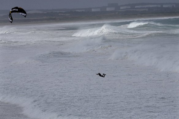 A kite surfer put it on the line at North Cronulla beach as big surf pounds the East coast.