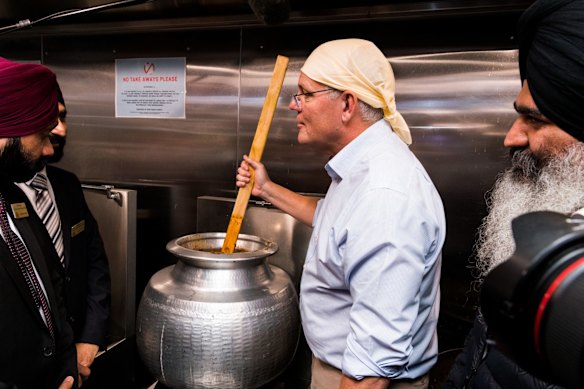 Australian Prime Minister Scott Morrison visits the Sikh community at Gurdwada Siri Guru Nanak Darbar Officer, in the seat of Latrobe, stirring a dahl/curry in the kitchen with community members. 