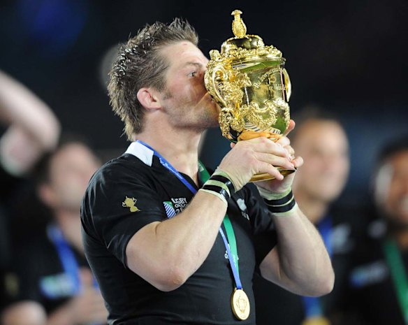Richie McCaw kisses the Webb Ellis trophy.