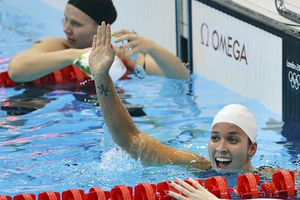Ranomi Kromowidjojo of the Netherlands waves after winning the women's 100m freestyle final.