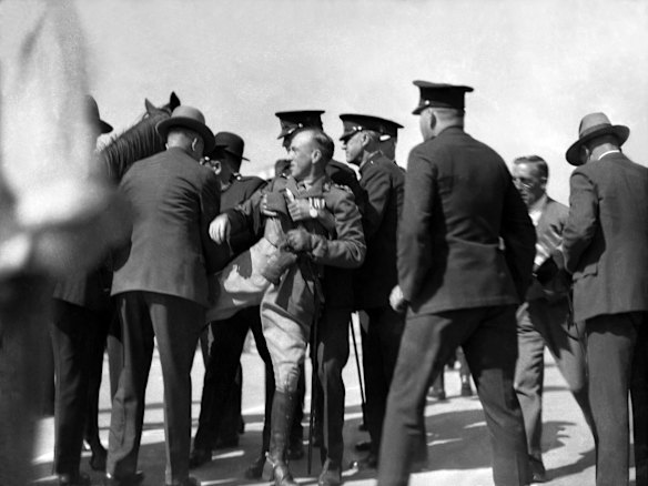 Francis de Groot is apprehended by police officers after cutting the ribbon, interrupting the opening of the Sydney Harbour Bridge.