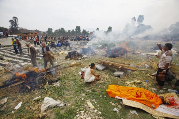 Nepalese people gather to cremate family members who fell victim to Saturday's earthquake, in Bhaktapur, Nepal.