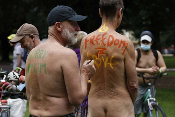 Cyclists share messages of freedom and love during the 2021 Naked Bike Ride in Melbourne, Australia.