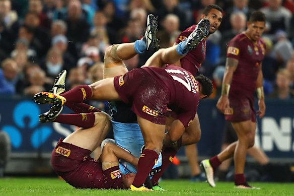 David Klemmer of the Blues is tackled.