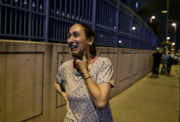 A woman stands and cries outside Istanbul's Ataturk airport.
