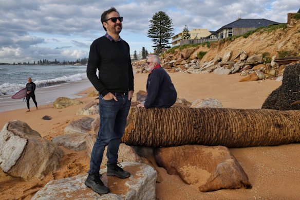 Dr Mitchell Harley and Angus Gordon on Narrabeen beach amongst the recent beach erosion and property damage.
