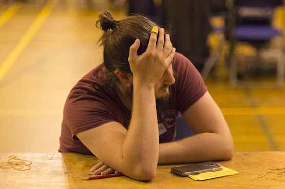A counter puts his hand to his head during counting at Llanishen Leisure Centre in Cardiff, Wales. 