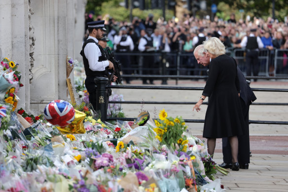 King Charles III and Camilla, Queen Consort, view floral tributes to the late Queen Elizabeth II outside Buckingham Palace in London on September 09, 2022.