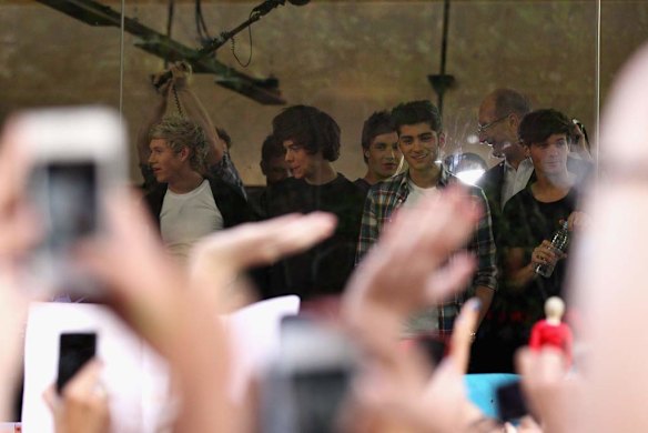 One Direction look out to fans during their visit to Sunrise Martin Place studio.