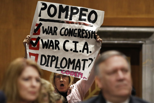 Retired US Army Colonerl Ann Wright, centre, protests the nomination of CIA Director Mike Pompeo, front right, for secretary of state, as he waits to testify before the Senate Foreign Relations Committee during a confirmation hearing.