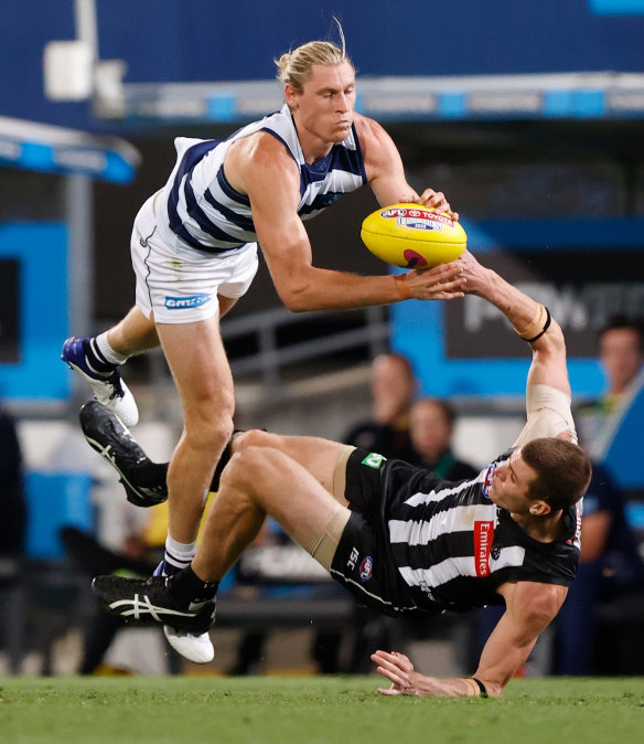 Stand over tactics: Geelong's Mark Blicavs and Collingwood's Mason Cox.