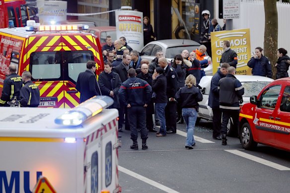 Police, paramedics and firefighters at the scene of the shooting in the south Paris on Thursday, January 8. 