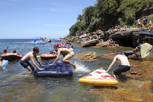 James Storer, Federico D'abate, and Liam Ricketts with their floaties at Gordon's Bay, in Sydney on New Years Day. 
