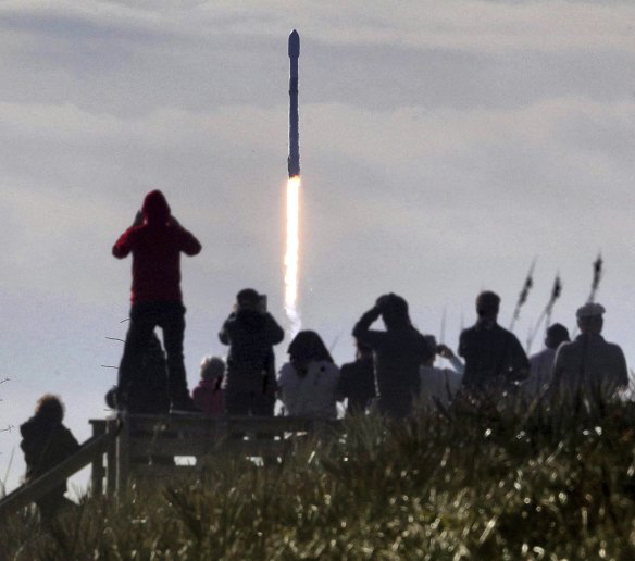 Visitors watch a Falcon 9 SpaceX rocket with a payload of approximately 60 satellites for SpaceX’s Starlink broadband network lift off last year.