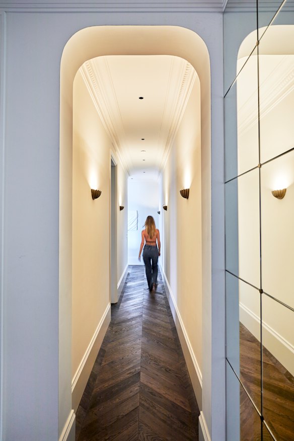 Upon entering, the formal hallway, lofty ceilings, curved archways and oak parquetry flooring create grandeur in an otherwise compact apartment.