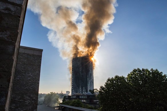 Smoke billows from a high-rise apartment building in west London Wednesday, June 14, 2017. A massive fire raced through the building early Wednesday, emergency officials said.